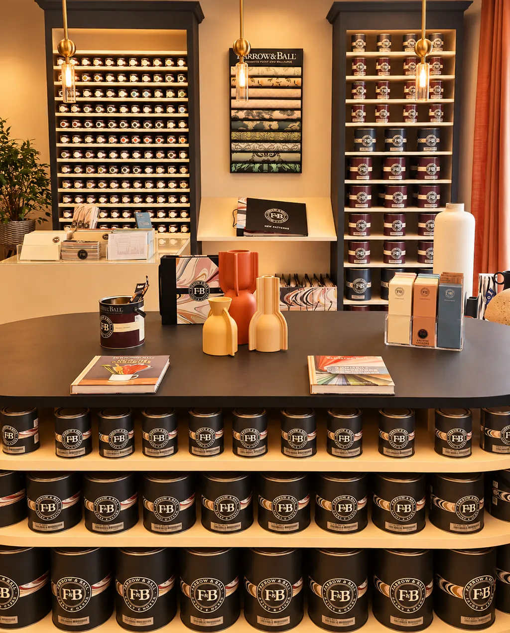 Le coin Farrow & Ball du Comptoir : bibliothèques de pots et de papiers peints, îlot chargé de pots Farrow & Ball